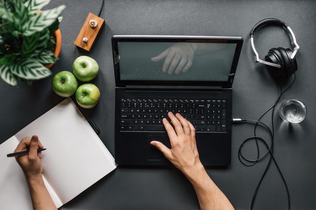 Millennial at laptop with healthy foods