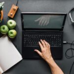 Millennial at laptop with healthy foods